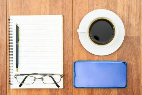 Top view image of coffee cup and cellphone on wooden table Stock Photos