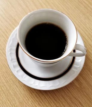 Top view image of a cup of black coffee on a wooden table Stock Photos