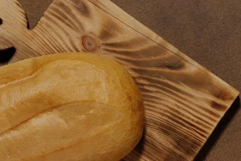 Top view image of a loaf of bread on a kitchen board. Stock Photos