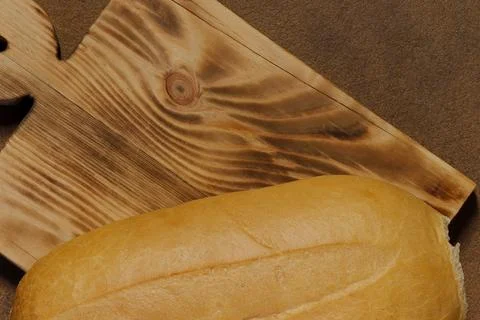 Top view image of a loaf of bread on a kitchen board. Stock Photos