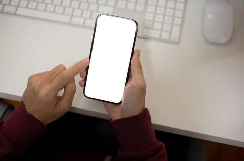 Top view image of a man using his smartphone at her office desk. A white-sc.. Foto stock