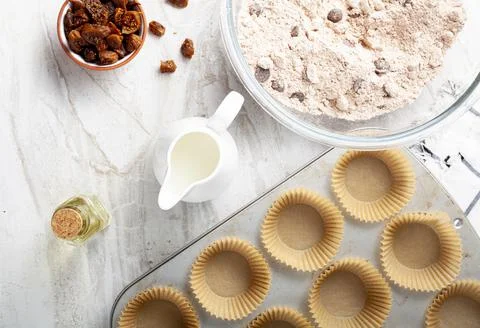 Top view image showing making of delicious fruit and nut cupcake on white mar Stock Photos