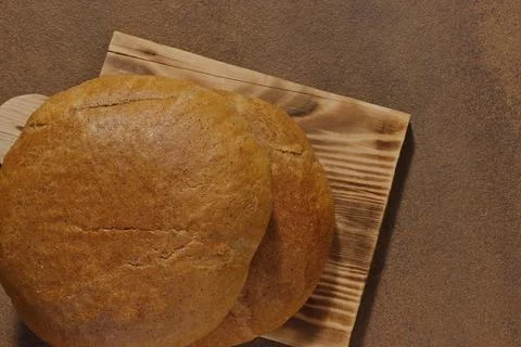 Top view image of two loaves of bread on a kitchen board. Stock Photos