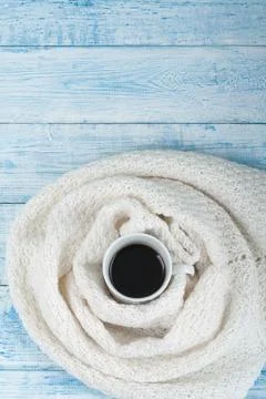 Top view image of white cozy knitted sweater with to cup of coffee on a woo.. Stock Photos