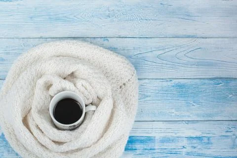 Top view image of white cozy knitted sweater with to cup of coffee on a woode Stock Photos