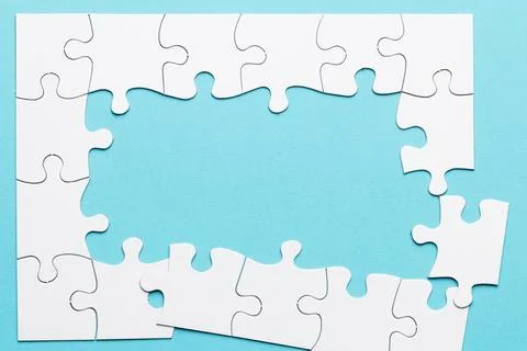 Top view incomplete puzzle frame blue backdrop 스톡 사진
