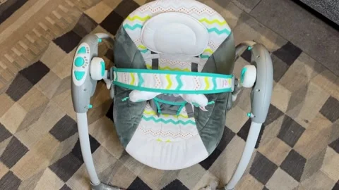 Top View Infant Swing Seat Close Up, Empty Baby Bouncer Chair with Safety Stock Footage 327434111