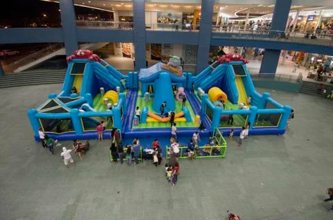 Top view of inflatable jumping castle indoors with children playing Stock Photos