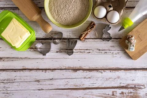 Top view of ingredients for baking Easter cookies and kitchen utensils, woode Stock Photos