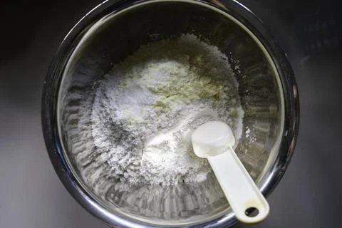 Top view of ingredients for making risolle skin in a stainless steel bowl. Stock Photos