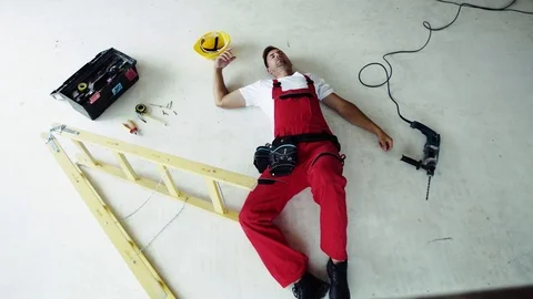 Top view of an injured man lying on the floor after an accident at work. Stock Footage