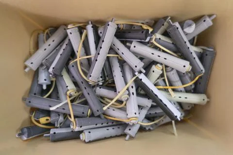 Top view inside a beige box with a lot of thin bicolor light and dark grey ro Stock Photos