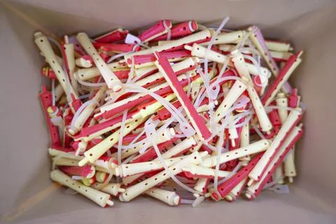 Top view inside a beige box with a lot of thin bicolor light yellow and red r Stock Photos