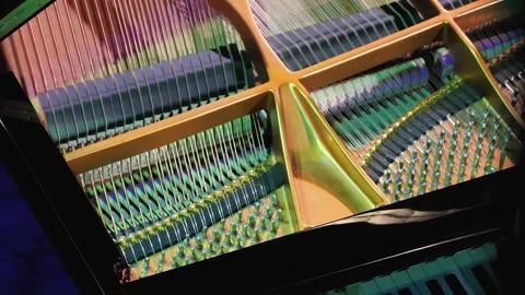 Top view of the inside of a grand piano. The hammers strike the strings Video stock 282757745