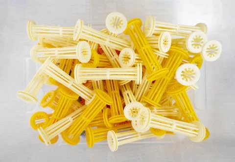 Top view inside a transparent box with a lot of yellow rollers for a perm, ha Stock Photos