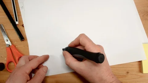 Top view, an interior architect's hand draws a key on a sheet of paper, ideal Stock Footage 104249508