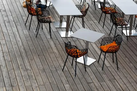Top view of the interior of the cafe with openwork chairs, bright pillows and Stock Photos