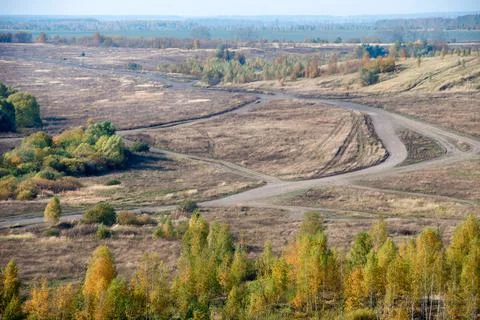 Top view of the intersection of country roads on a field in the countryside Stock Photos