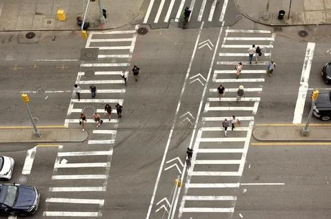Top view at the intersection with peope on zebra crossings. Stock Photos