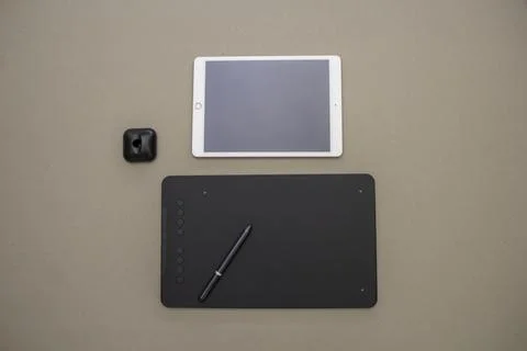 A top view of an iPad and a black graphic tablet with a digital pen put on it Stock Illustration