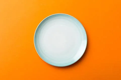 Top view of isolated of colored background empty round blue plate for food... Stock Photos