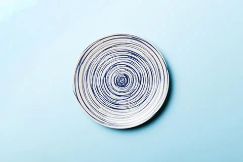 Top view of isolated of colored background empty round blue plate for food. E Stock Photos