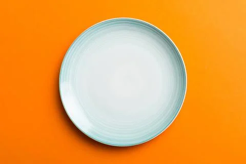 Top view of isolated of colored background empty round blue plate for food. E Stock Photos
