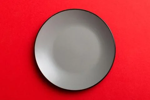 Top view of isolated of colored background empty round gray plate for food. E Stock Photos