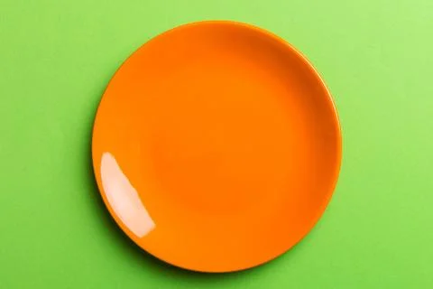 Top view of isolated of colored background empty round orenge plate for food. Stock Photos