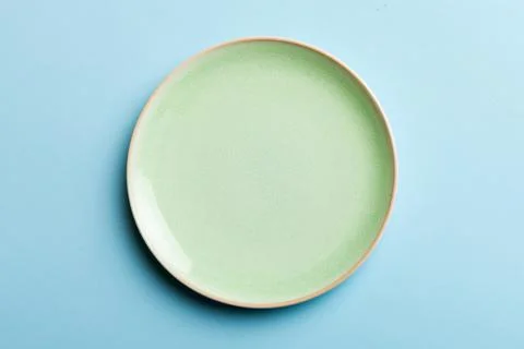 Top view of isolated of colored background empty round green plate for food.  Stock Photos