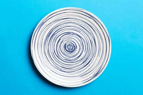 Top view of isolated of colored background empty round blue plate for food. E Stock Photos