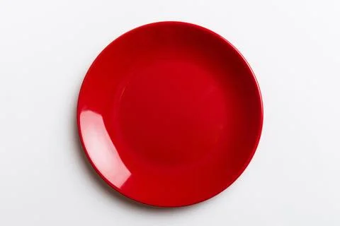 Top view of isolated of colored background empty round red plate for food. .. Stock Photos