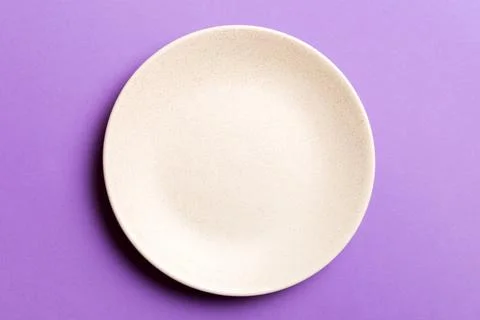 Top view of isolated of colored background empty round beige plate for food.  Stock Photos
