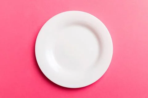 Top view of isolated of colored background empty round white plate for food.. Stock Photos