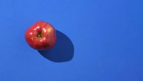 Top view of isolated red apple on a blue background Stock Photos