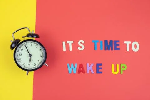 Top view of It's time to wake up wording with classic clock Stock Photos