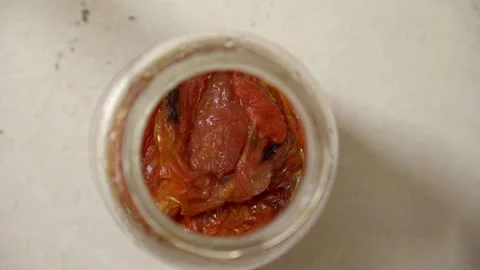 Top view of a jar of dehydrated tomatoes 動画素材 323824547