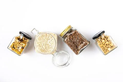 Top view of jars full of oats and various crunchy granola Stock Photos