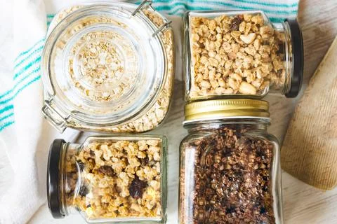 Top view of jars full of oats and various crunchy granola Stock Photos