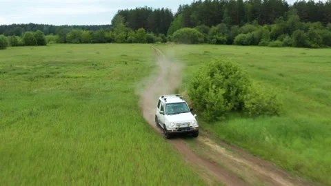 Top view of a jeep driving on a dirt road in nature Stock Footage 168101034