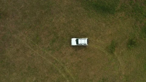 Top view of a jeep driving through a field of grass Stock Footage 168102140