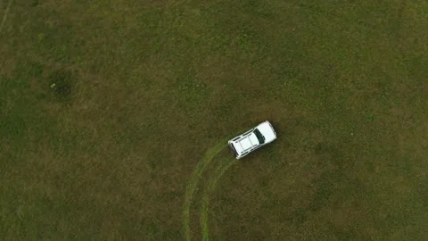 Top view of a jeep driving through a field of grass Stock Footage 168102633