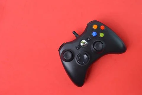 Top view of joystick game controller isolated on a red background. Stock Photos