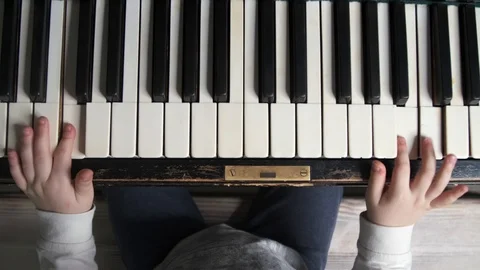 Top View of Kid's Hands Playing Piano Stock Footage 125397785