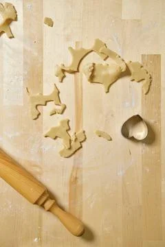 Top view of kitchen table with rests and cuts of dough Stock Photos