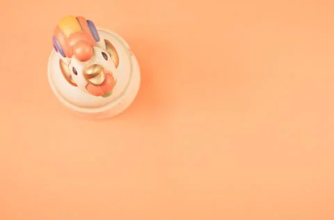 A top view of a kitchen timer in a cute chicken shape on orange background wi Stock Photos