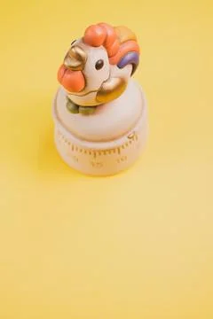 A top view of a kitchen timer in a cute chicken shape on yellow background wi Stock Photos