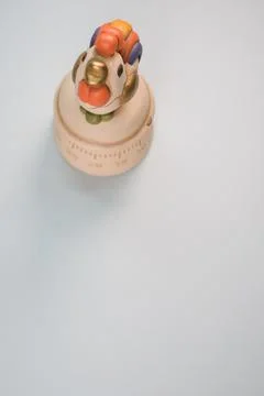 A top view of a kitchen timer in a cute chicken shape on gray background with Stock Photos