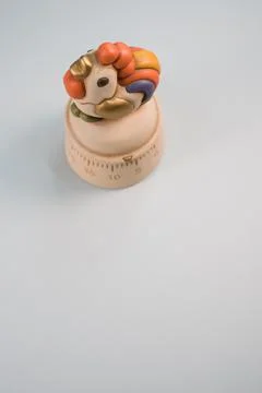 A top view of a kitchen timer in a cute chicken shape on gray background with Stock Photos