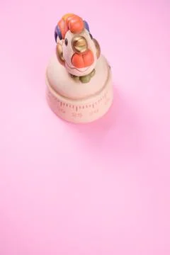 A top view of a kitchen timer in a cute chicken shape on pink background with Stock Photos